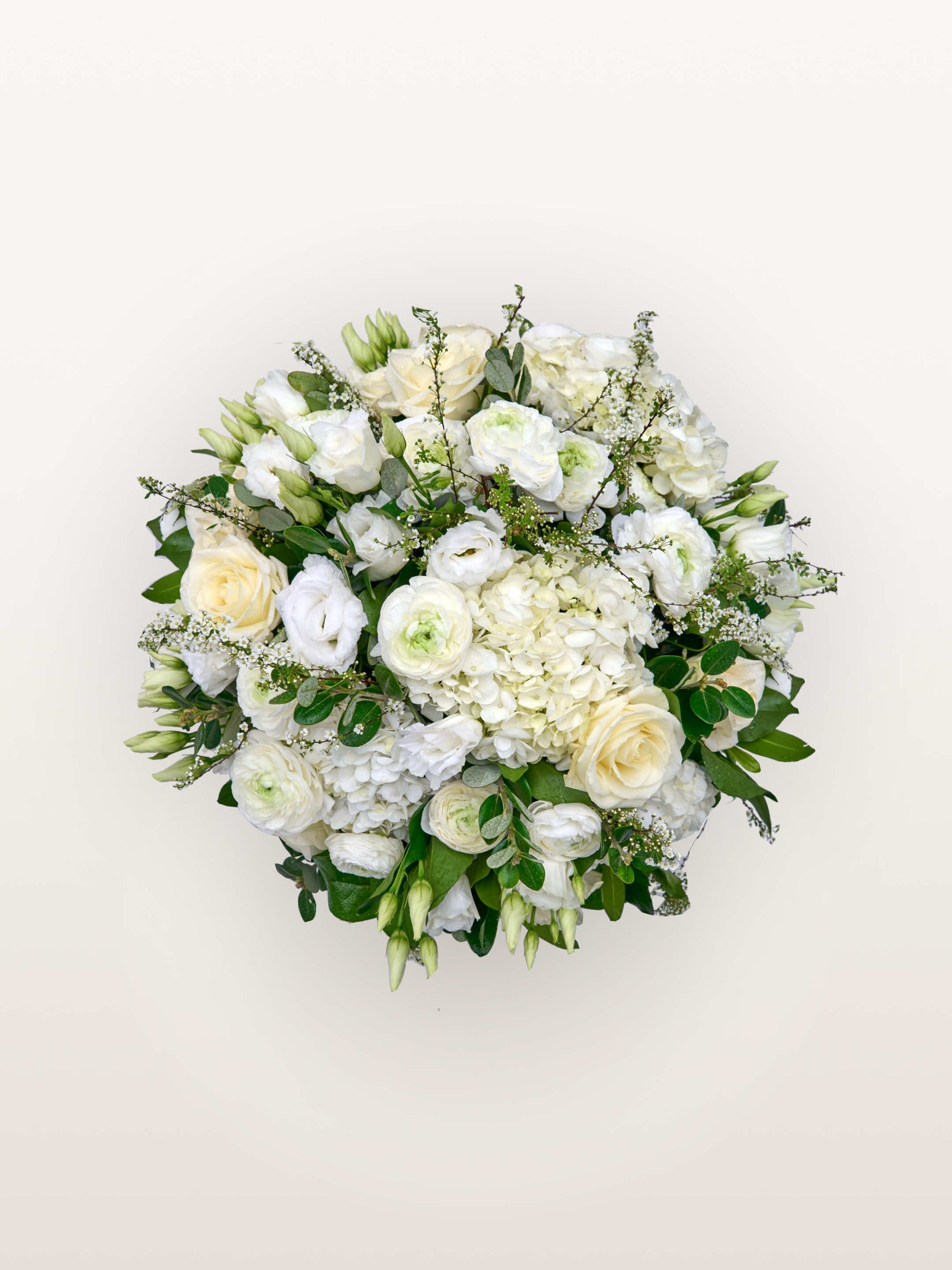 Reine Blanche M, roses, renoncules et hortensias blancs assemblés en bouquet rond avec feuillage